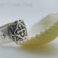 Silver cross ring.