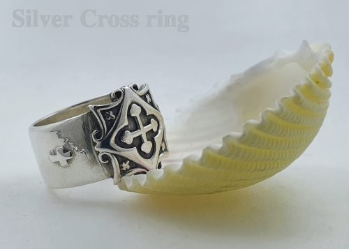 Silver cross ring.